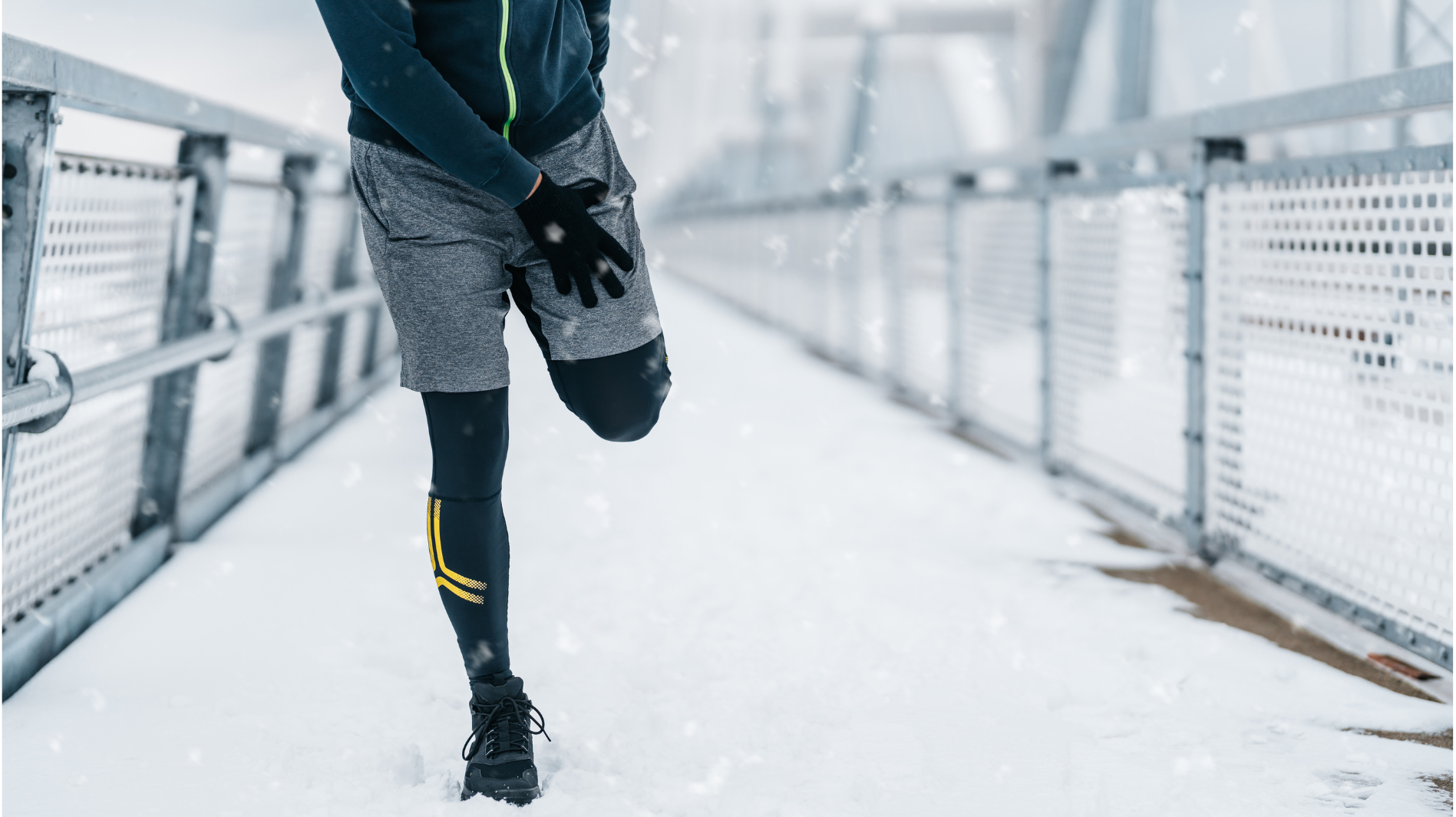 person stretching their leg during a snowy run for winter joint pain relief