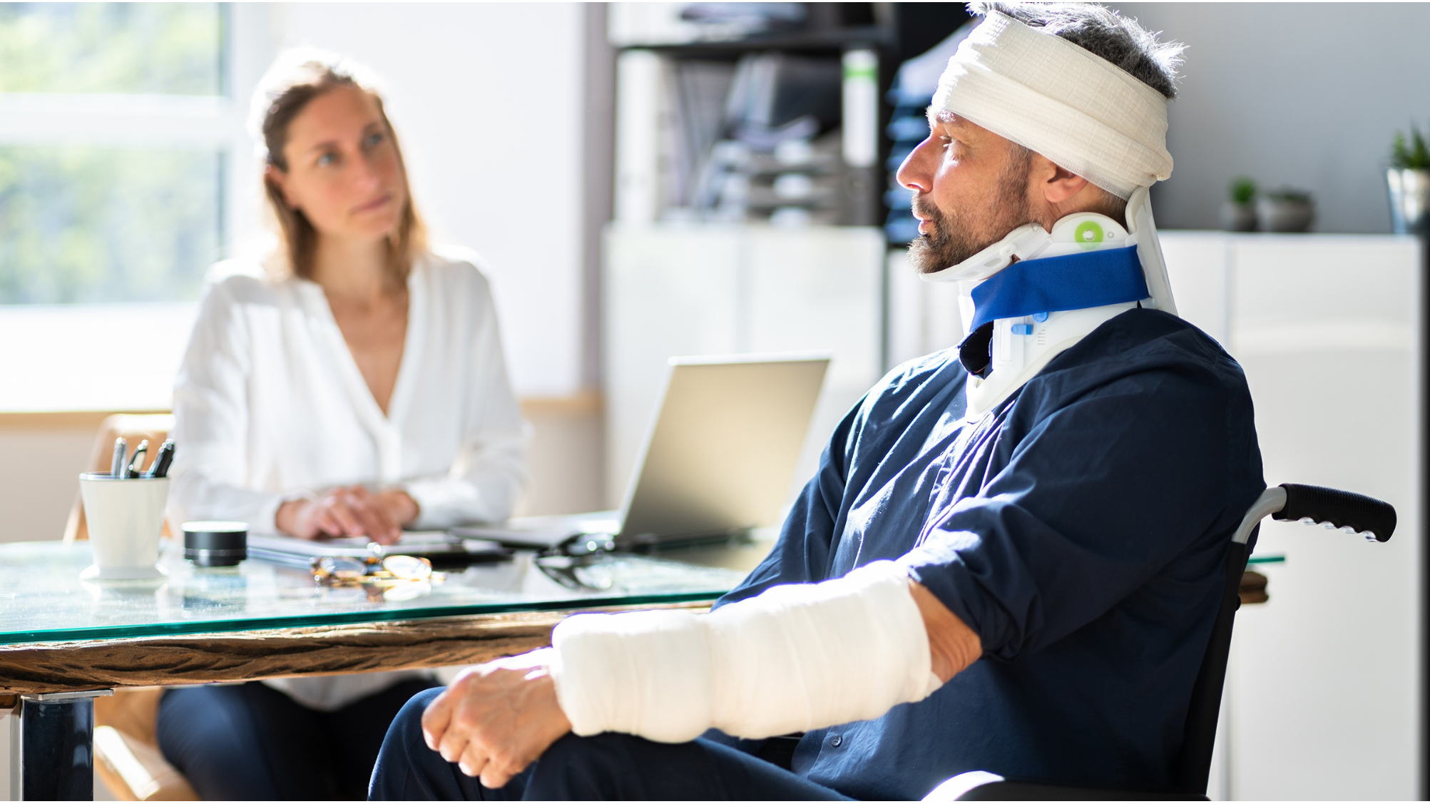 man in wheelchair suffering from chronic pain after brain injury
